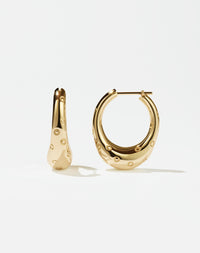 A pair of large hoop earrings made of gold, designed to resemble strawberries.