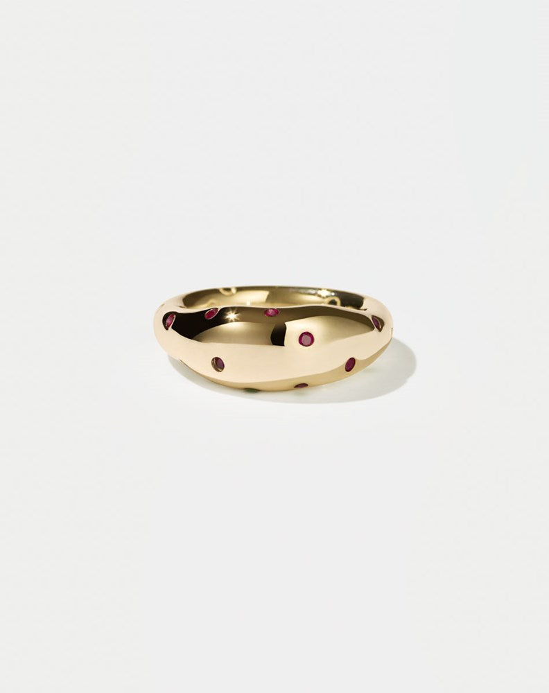 A  gold ring with round brilliant rubies set in Swiss settings