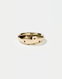 A  gold ring with round brilliant rubies set in Swiss settings