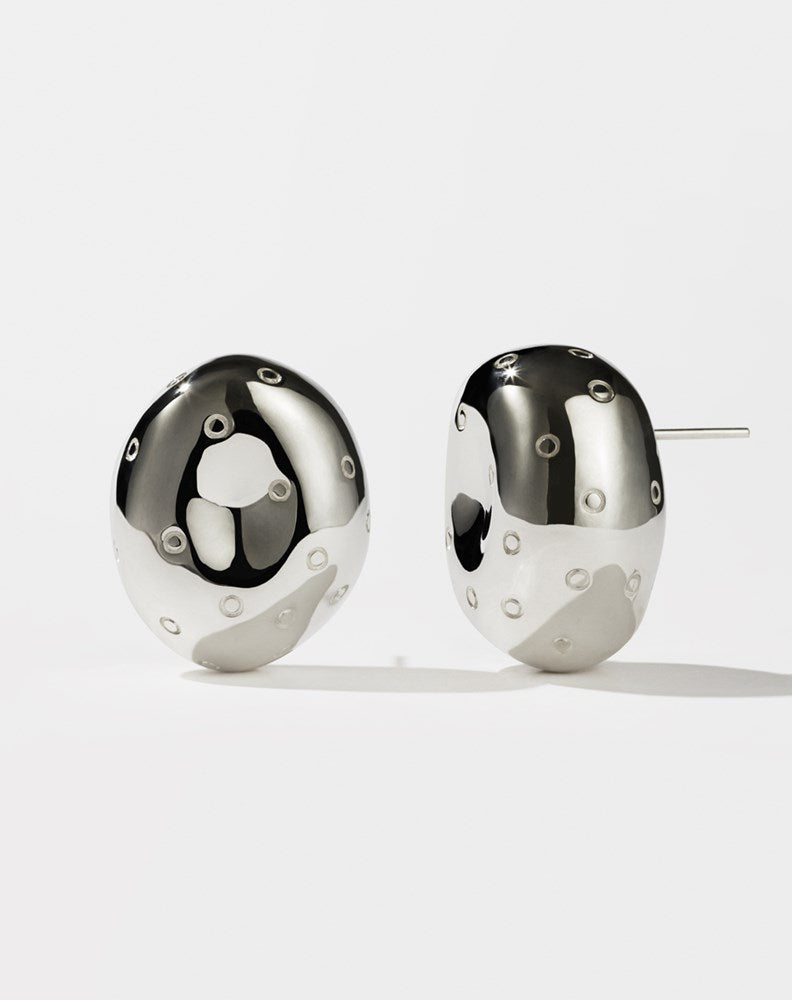 A pair of sterling silver earrings designed in the shape of abstract strawberries with seeds resembling texture on a white background.