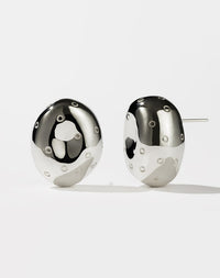 A pair of sterling silver earrings designed in the shape of abstract strawberries with seeds resembling texture on a white background.