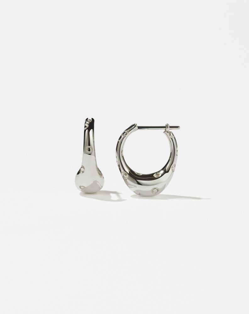 A pair of sterling silver hoop earrings with a small abstract strawberry design, featuring circles along the hoop to represent strawberry seeds.