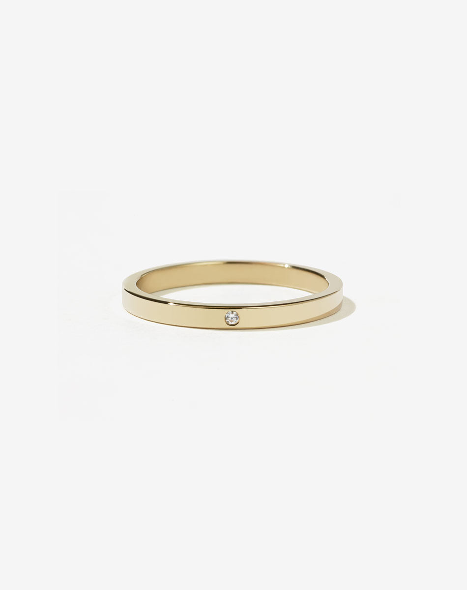 A minimalist gold band with a single stone set