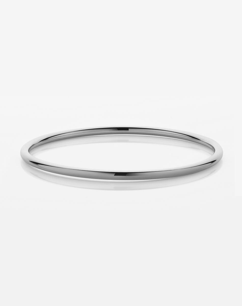 A simple, smooth sterling silver bangle bracelet on a white background.
