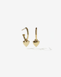 A pair of 9ct solid gold hoop earrings with a small heart charm attached to each hoop.
