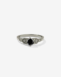 Meadowlark Jewellery’s vintage inspired 0.5ct Eternal Solitaire Engagement Ring in 14ct White Gold, claw set with a round brilliant cut black diamond centre stone. Atop a fine square band. A timeless, floral Ceremonial design made to order in New Zealand. Pair with the diamond pave set Eternal Wedding Band.