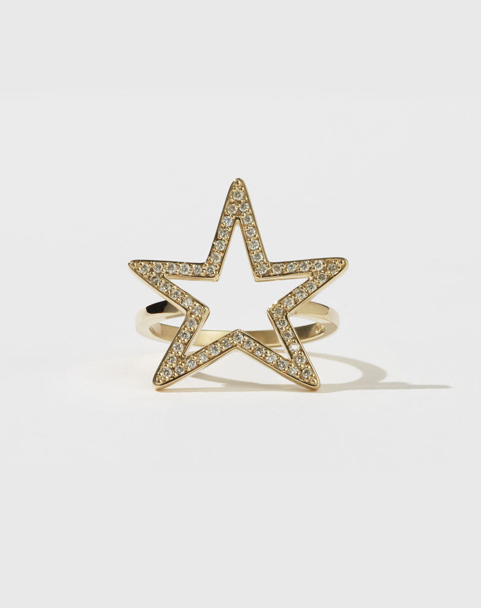 A gold ring featuring a star-shaped design with pavé diamonds