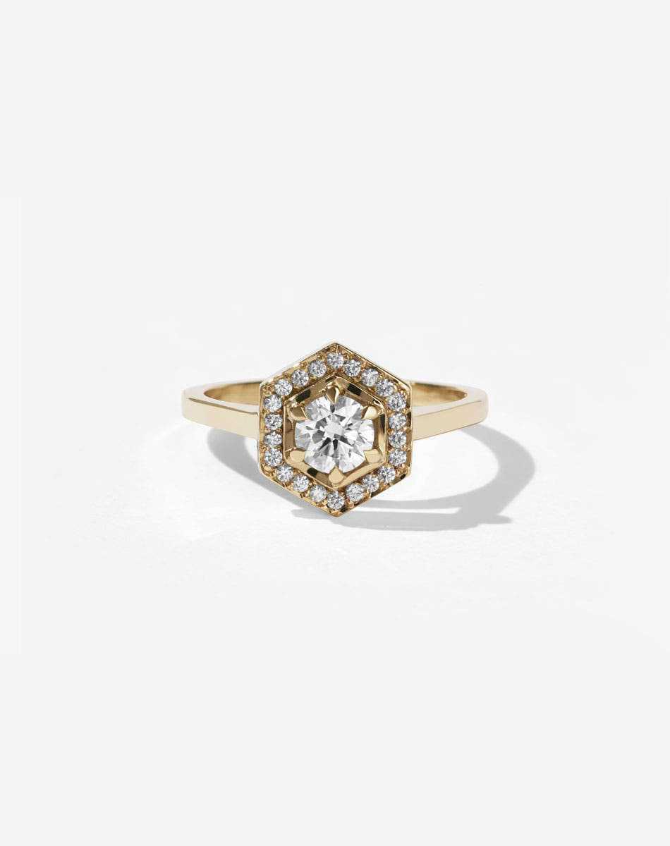 Meadowlark Jewellery’s iconic Hex Engagement Ring 0.5ct in 9ct Yellow Gold, claw set with 0.61ct round brilliant cut white diamond centre stone, surrounded by a hexagon halo of pave set white diamonds. One of our most beloved and modern Ceremonial designs, made to order in New Zealand. Pair with our bestseller, the Diamond Eternity Band.