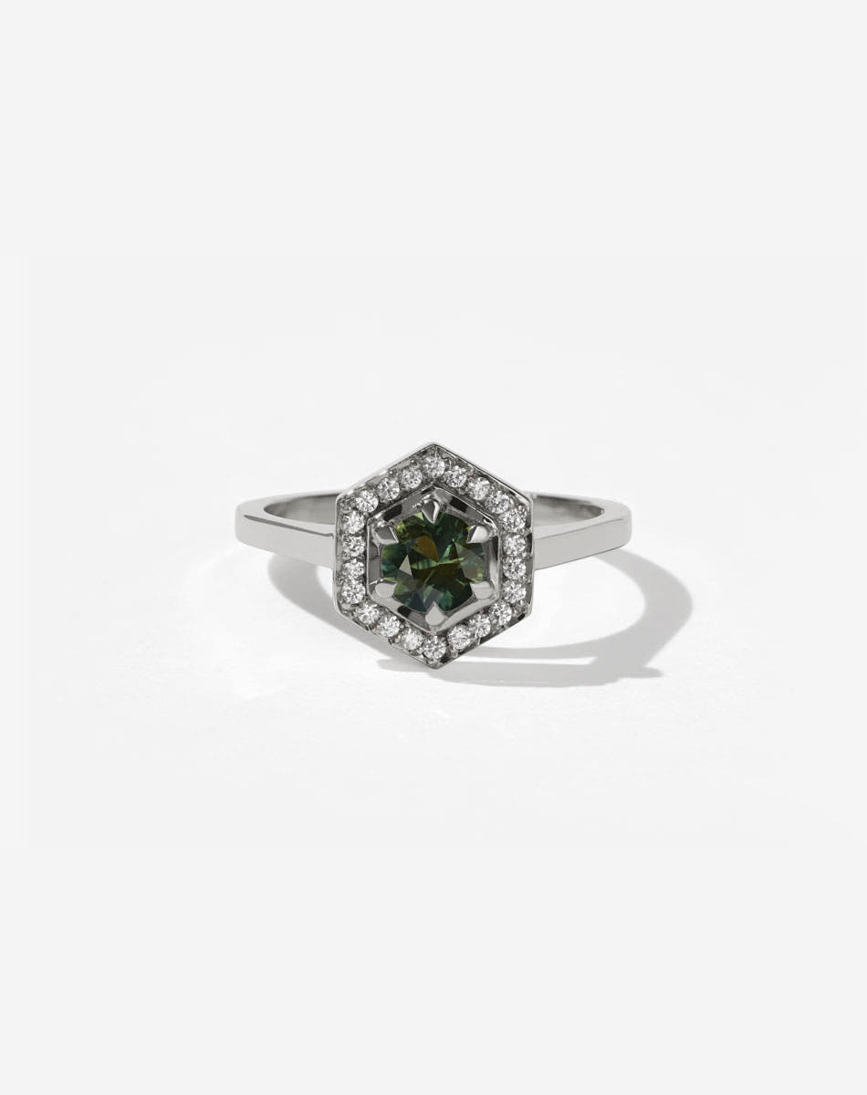 Meadowlark Jewellery’s iconic Hex Engagement Ring 0.5ct in Platinum, claw set with 0.61ct round brilliant cut green sapphire centre stone, surrounded by a hexagon halo of pave set white diamonds. Fully traceable and ethically sourced blue and green sapphires from Queensland, Australia. One of our most beloved and modern Ceremonial designs, made to order in New Zealand. Pair with our bestseller, the Diamond Eternity Band.
