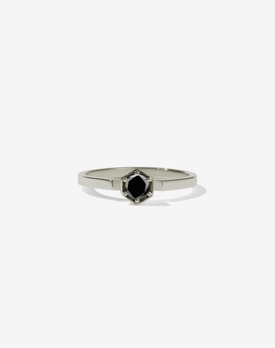 Meadowlark Jewellery’s classic Hexagon Solitaire Engagement Ring in 18ct White Gold, claw set with a 0.25ct round brilliant cut black diamond atop a fine square band. A minimalist, yet bold Ceremonial design made to order in New Zealand.