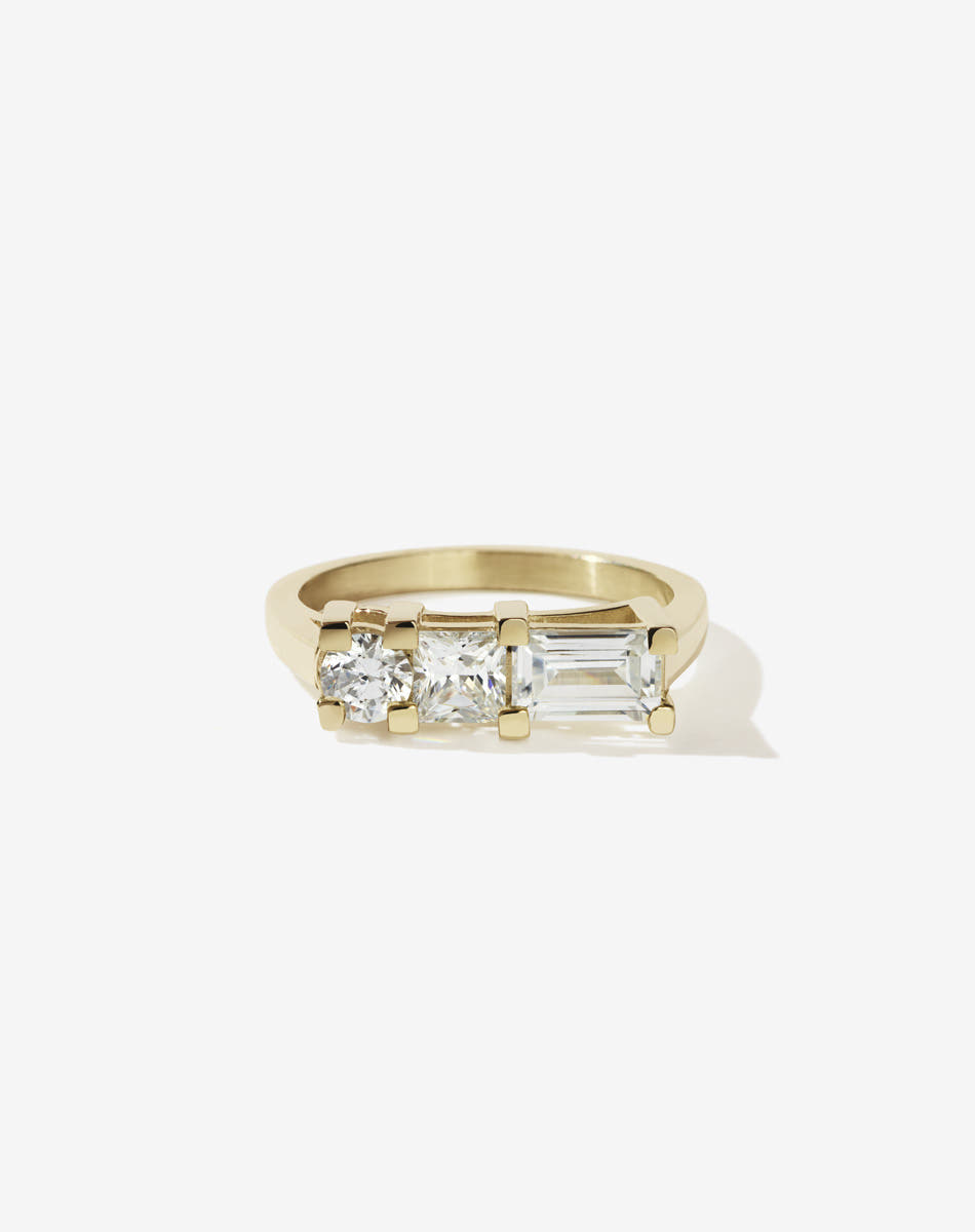 Meadowlark Jewellery’s architecture inspired 1.1ct Hilma Engagement Ring in 9ct Yellow Gold, claw set with a round brilliant cut, princess cut and baguette cut white diamond. Atop a fine square band. A bold and alternative Ceremonial design made to order in New Zealand. Pair with our modern Stella Ring.