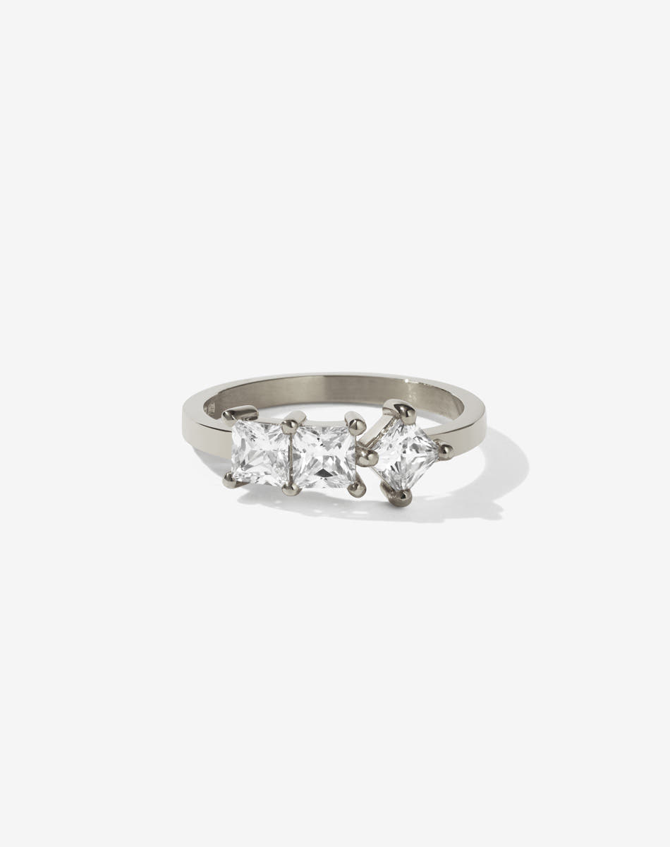 Meadowlark Jewellery’s modern 1.20ct Imogen Engagement Ring in 18ct White Gold, claw set with three princess cut white diamonds. Atop a fine square band. A graphic 3 stone engagement ring, inspired by art and architecture, this Ceremonial design is made to order in New Zealand.
