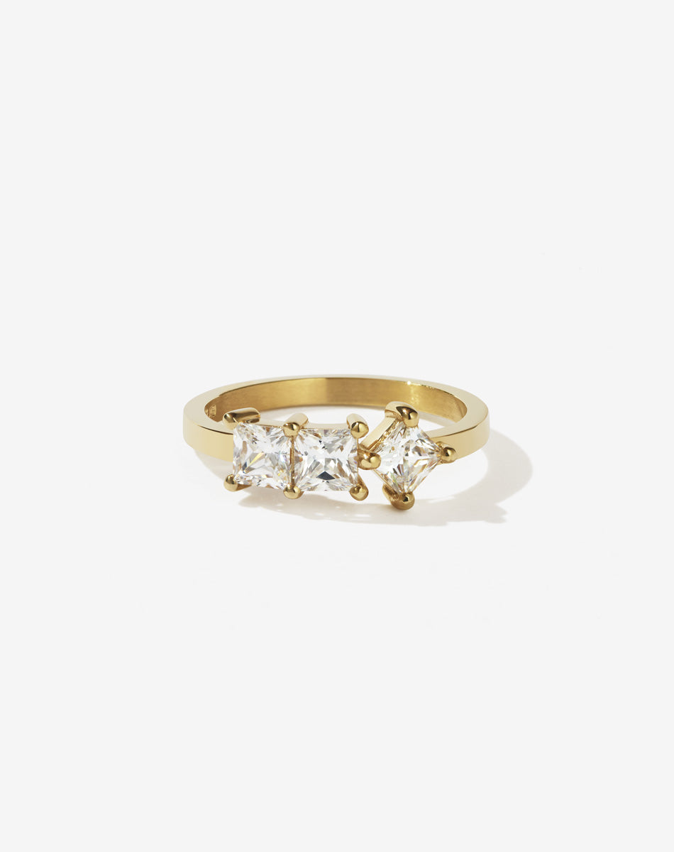 Meadowlark Jewellery’s modern 1.20ct Imogen Engagement Ring in 18ct Yellow Gold, claw set with three princess cut white diamonds. Atop a fine square band. A graphic 3 stone engagement ring, inspired by art and architecture, this Ceremonial design is made to order in New Zealand.

