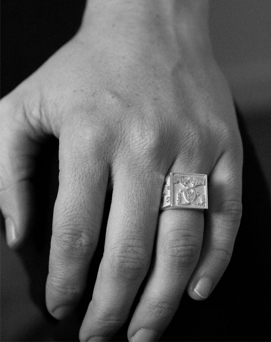 A heavy weighted sterling silver ring with a collage of artworks, designed in collaboration with NZ artist Andrew McLeod. Worn on hand.