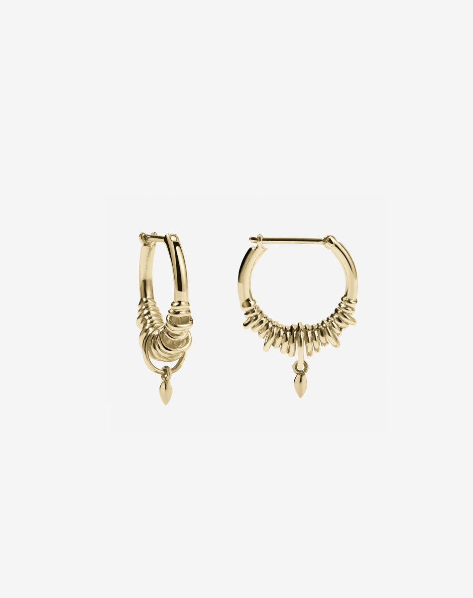 A pair of small hoop earrings made in gold, with a series of rings suspended on a hoop, with small charm. 