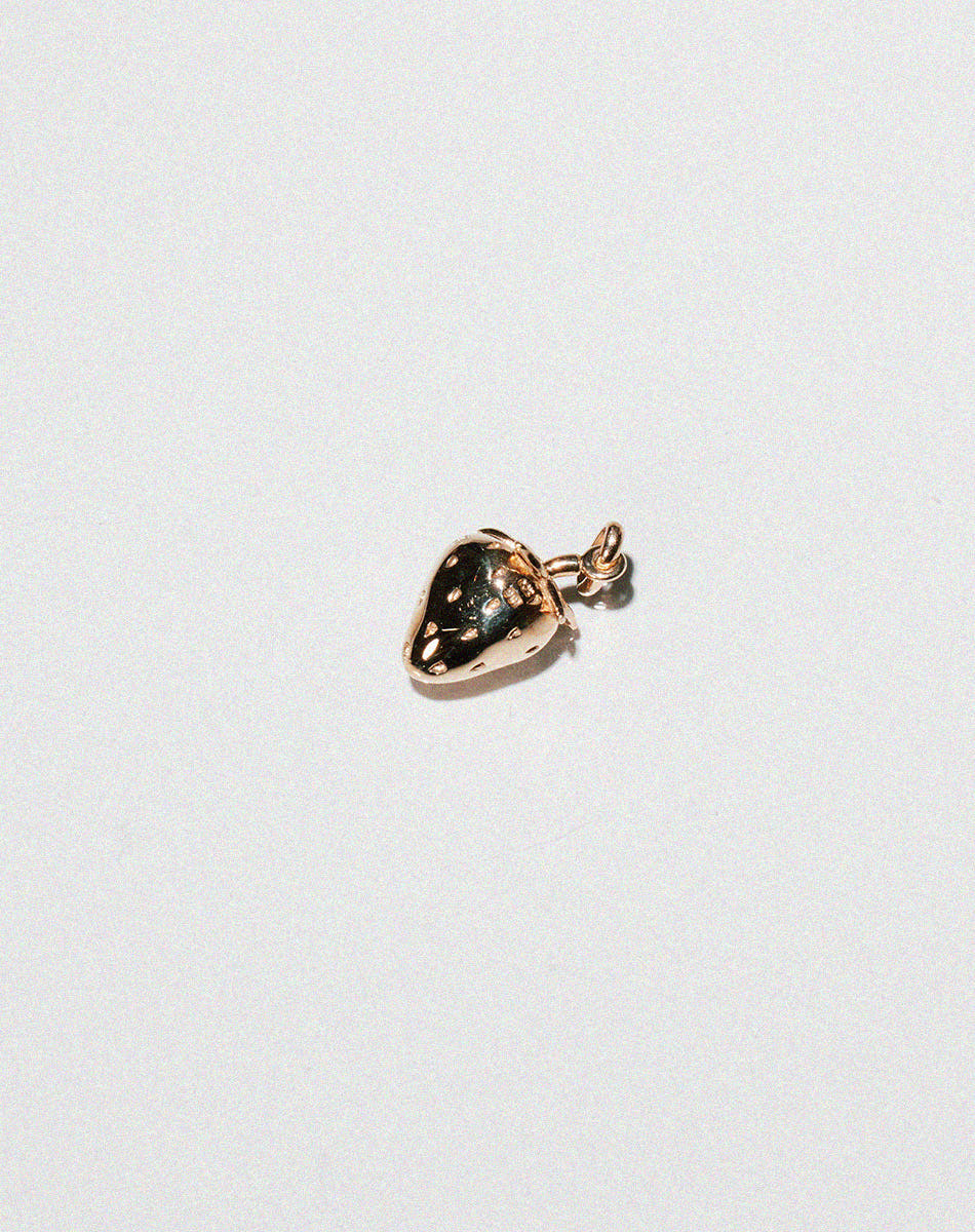 Gold charm in the shape of a cute strawberry