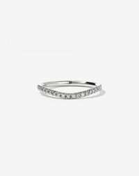 A round white gold band with small white diamonds set in a french pave style, halfway around the band.