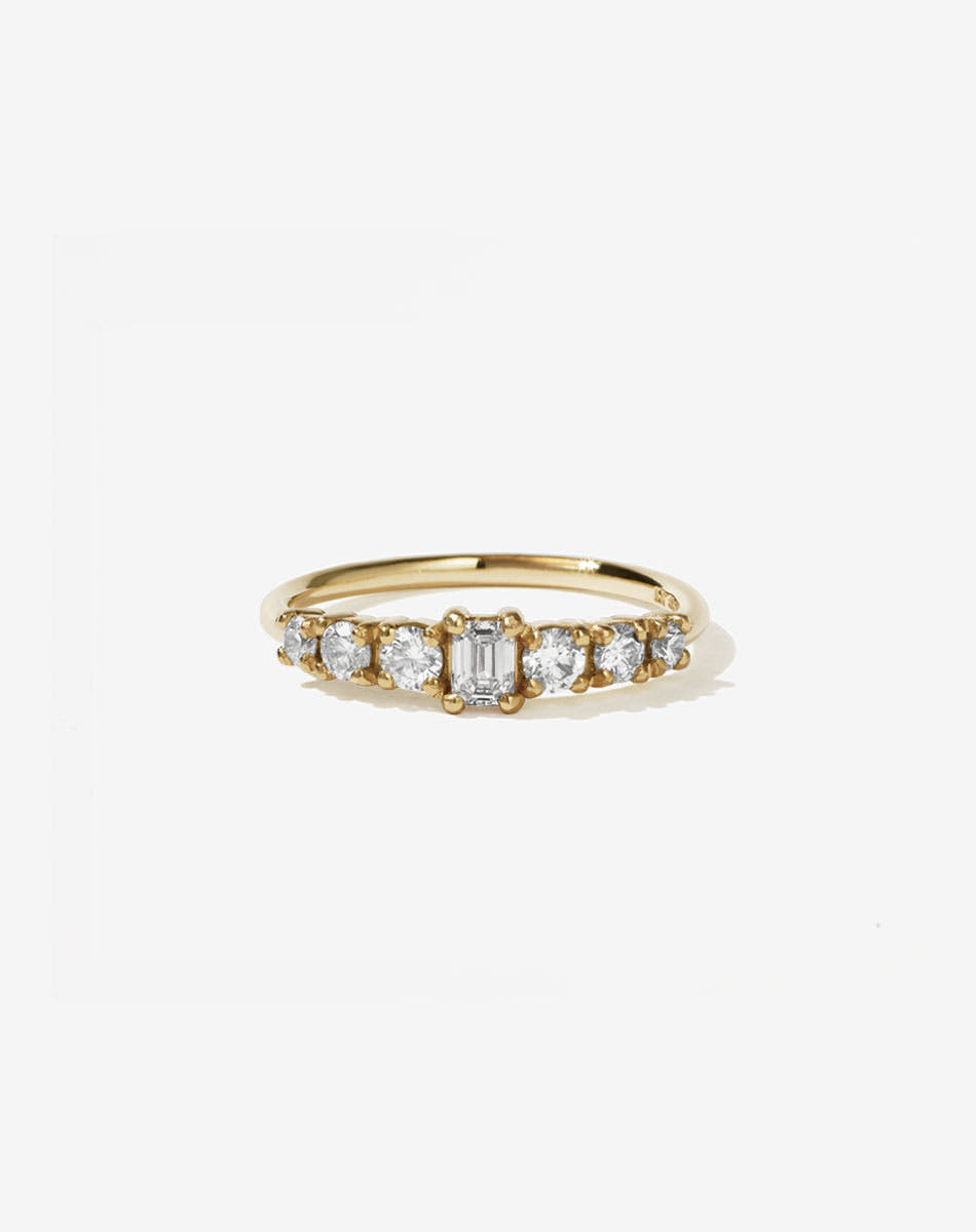 Meadowlark Jewellery’s beautiful Amelie Engagement Ring in 9ct Yellow Gold, claw set with 0.70ct emerald cut and round brilliant cut white diamonds atop a fine round band. A low set, petite seven stone engagement ring this Ceremonial design made to order in New Zealand.