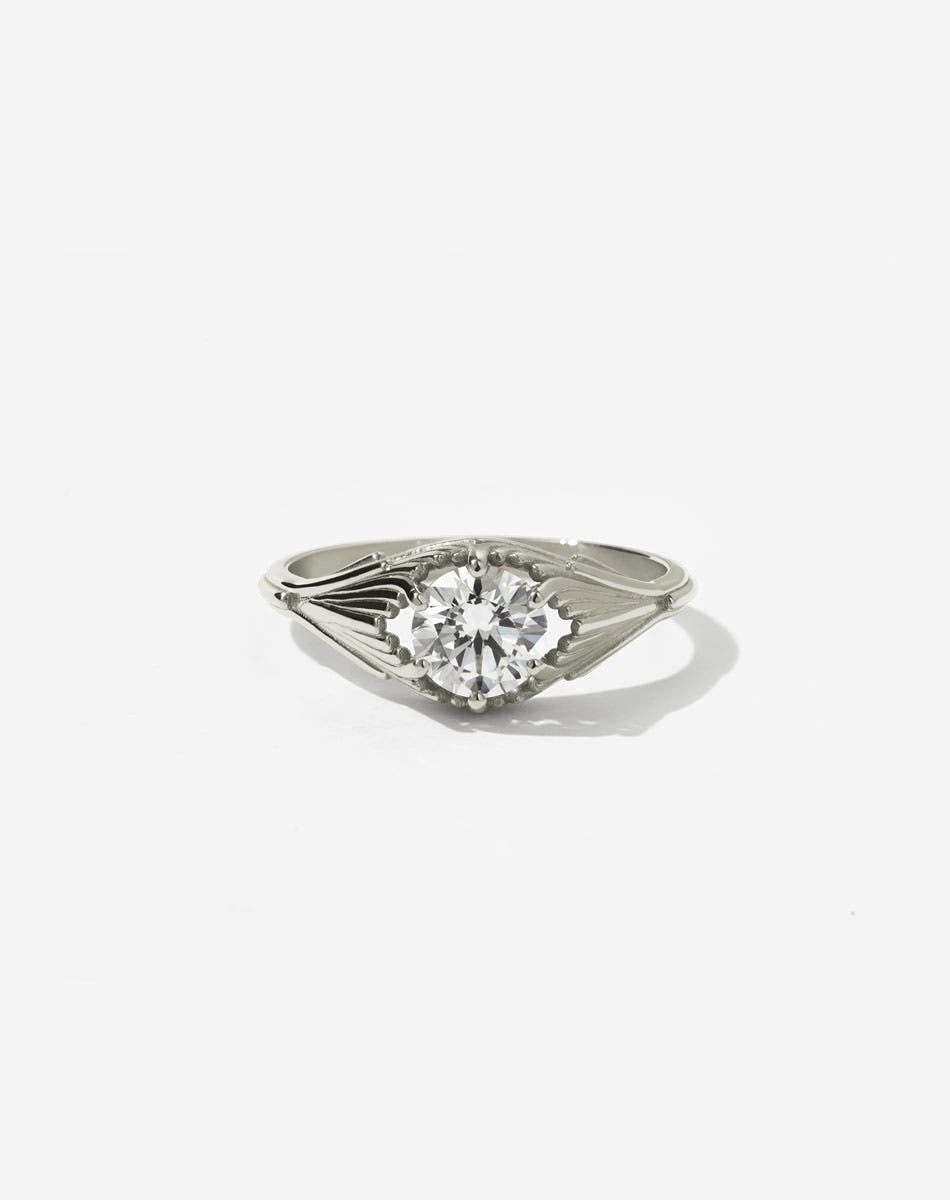 Meadowlark Jewellery’s vintage inspired Aphrodite Engagement Ring in 9ct White Gold, claw set with a 0.84ct round brilliant cut white diamond. An iconic Ceremonial design, made to order in New Zealand. Inspired by our popular Vita Stud Earrings and Carlo Giorgi's iconic 1970's Ginkgo Leaf Lamp. Pair with our diamond pave set Aphrodite Wedding Band.