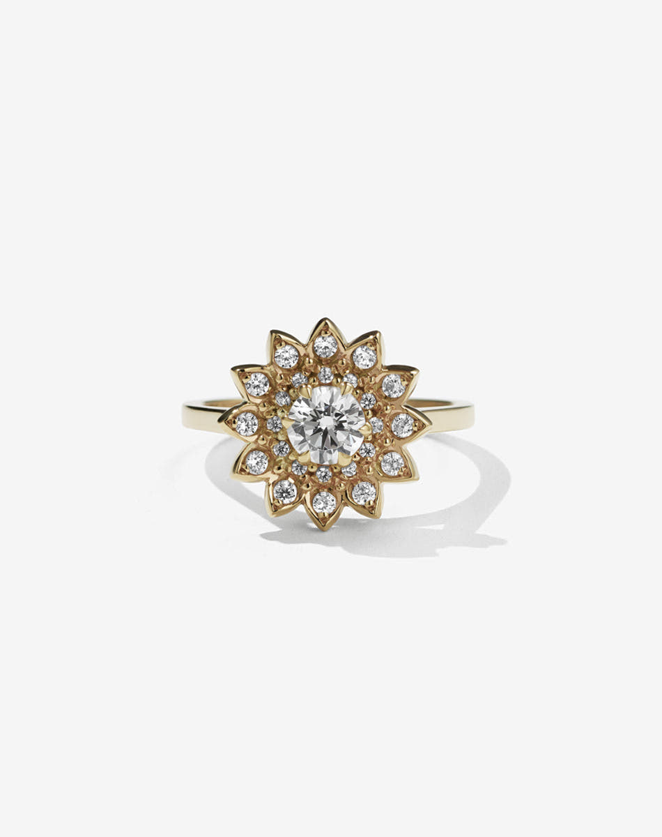 Diamond: Meadowlark Jewellery’s floral Dahlia Engagement Ring in 9ct Yellow Gold, claw set with 0.67ct round brilliant cut white diamond centre stone, surrounded by a halo of pave set white diamonds and diamond set petals. A modern and alternative Ceremonial design, made to order in New Zealand. Pair with our bestseller, the Diamond Eternity Band.