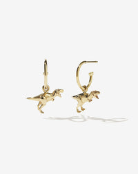 A pair of gold-colored dinosaur charms attached to small gold hoop earrings.