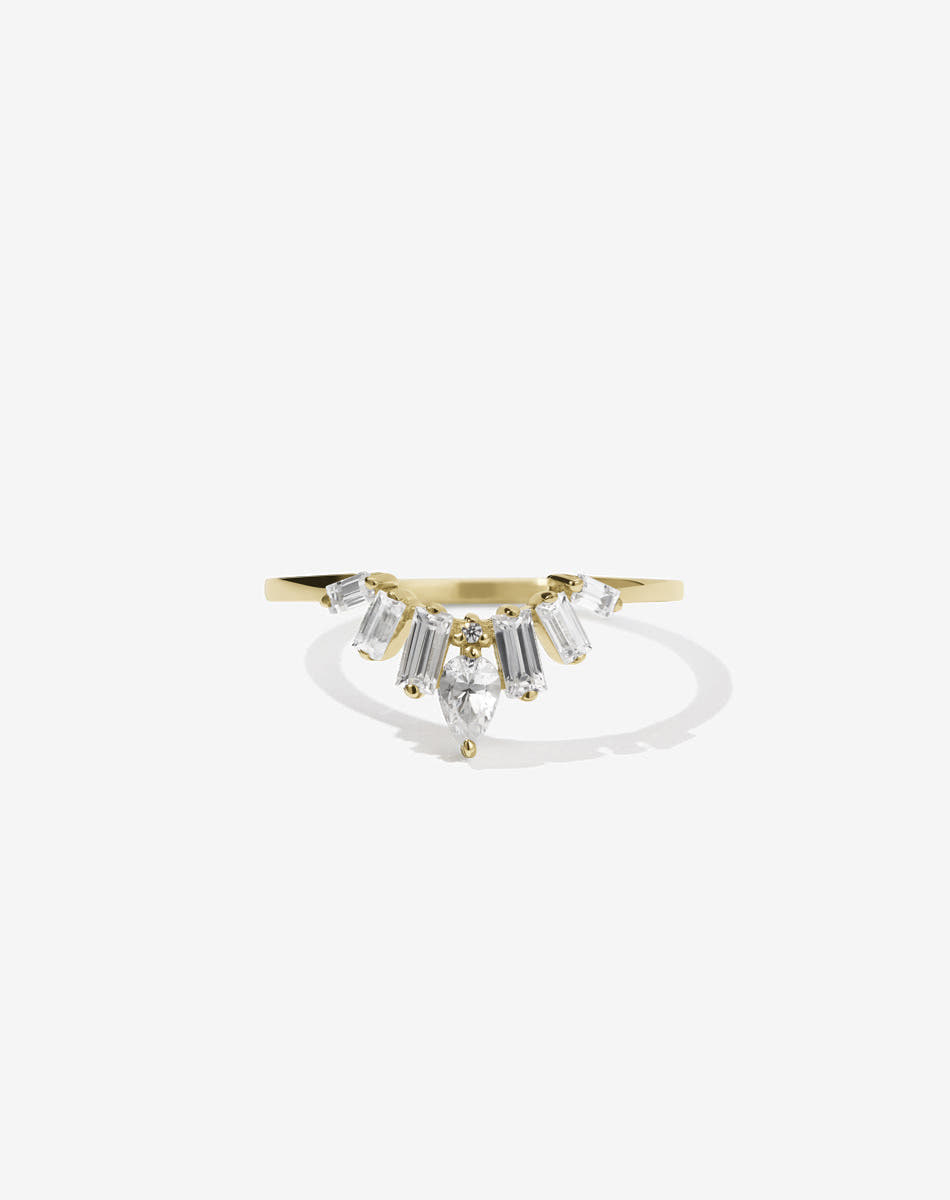 Meadowlark Jewellery’s vintage inspired Etta Engagement Ring in 18ct Yellow Gold, claw set with a pear cut white diamond centre stone, six baguette cut white diamonds, accented on each side with round brilliant cut white diamonds. Atop a fine square band. A Ceremonial design made to order in New Zealand. Wear alone or as a wedding band with a solitaire engagement ring.