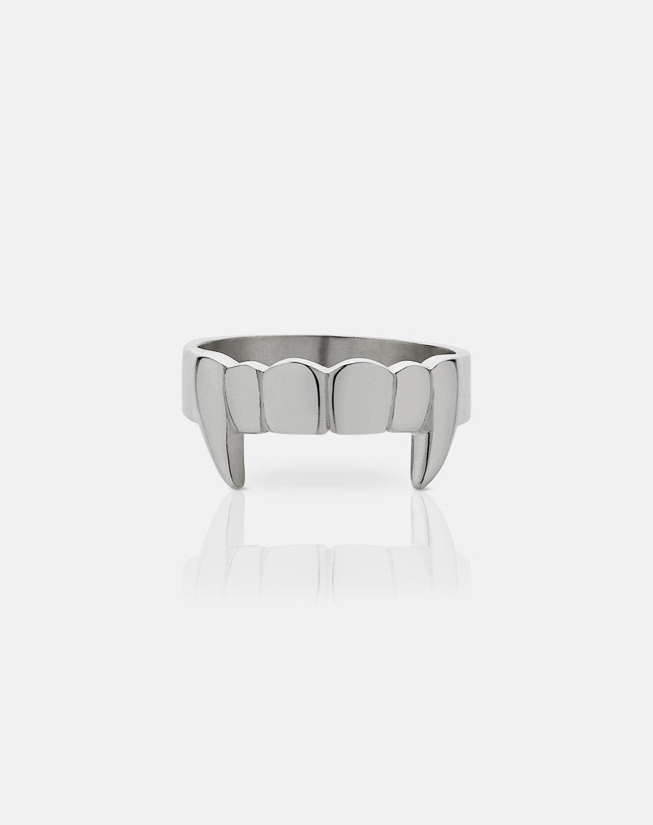 A sterling silver ring with a flat band featuring etched teeth and fang detailing.
