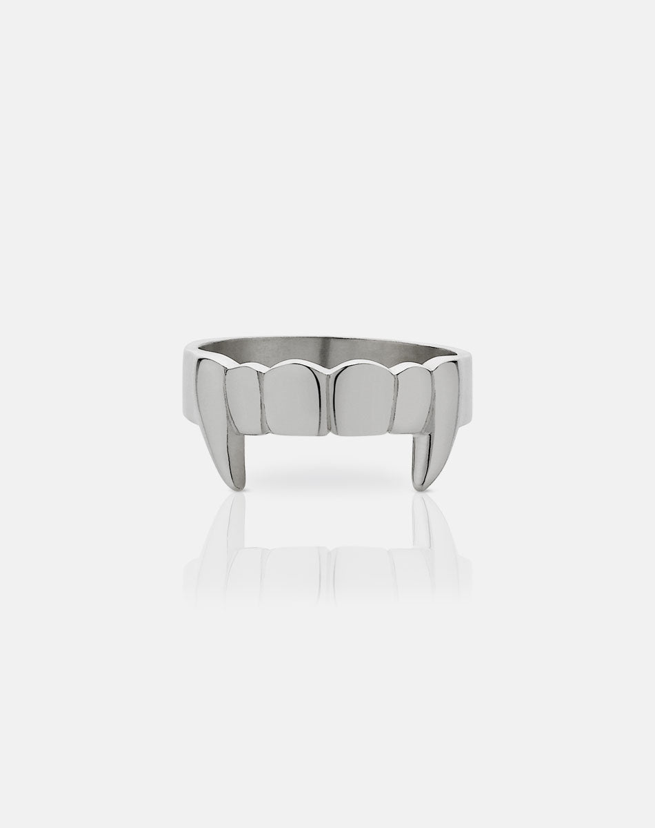 A sterling silver ring with a flat band featuring etched teeth and fang detailing.