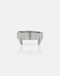 A sterling silver ring with a flat band featuring etched teeth and fang detailing.