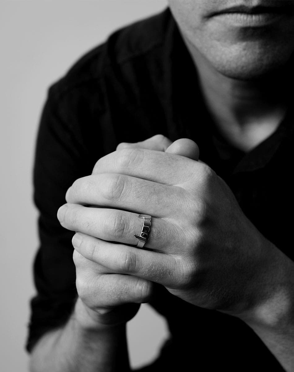 Fang ring worn on a hand.