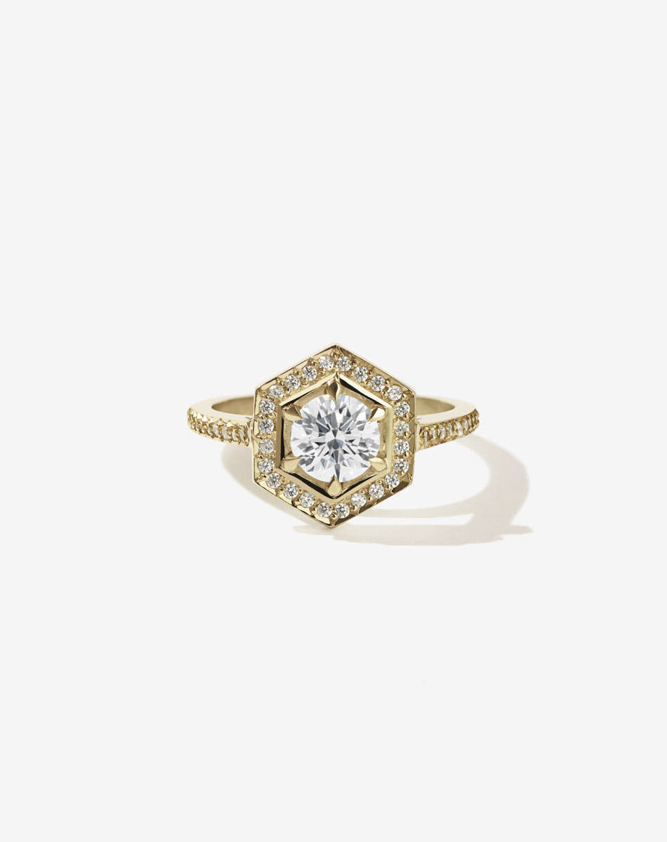 Meadowlark Jewellery’s iconic Hex Engagement Ring in 9ct Yellow Gold, claw set with 1.08ct round brilliant cut white diamond centre stone, surrounded by a hexagon halo of pave set white diamonds. Finished with a fine square band, diamond pave set halfway. One of our most beloved and modern Ceremonial designs, made to order in New Zealand. Pair with our bestseller, the Diamond Eternity Band.
