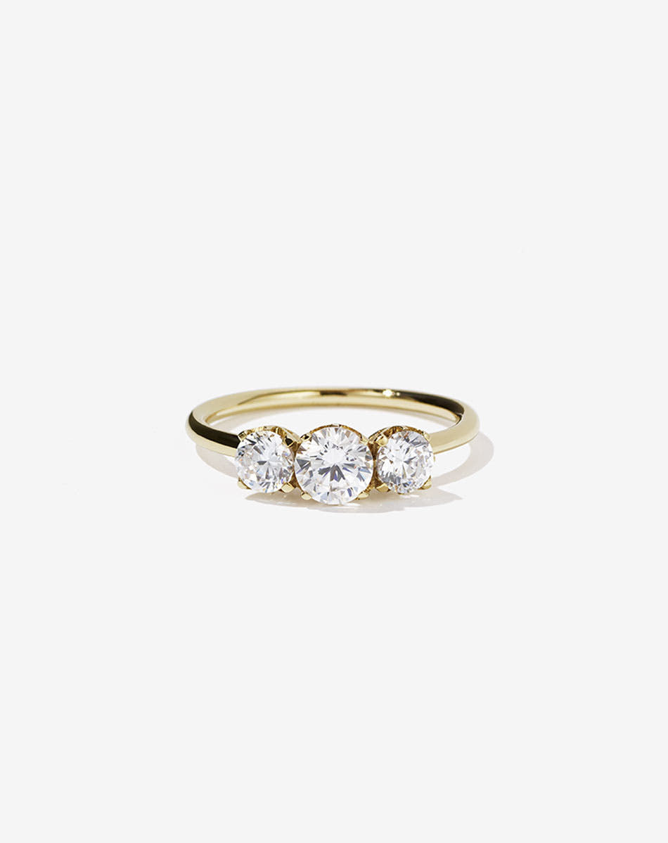 A classic three stone engagement ring in yellow gold with diamonds.