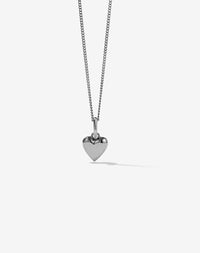 A sterling silver necklace with a small heart-shaped charm pendant attached to a delicate chain.
