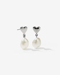 A pair of sterling silver earrings featuring a mini heart stud with freshwater pearl drops.