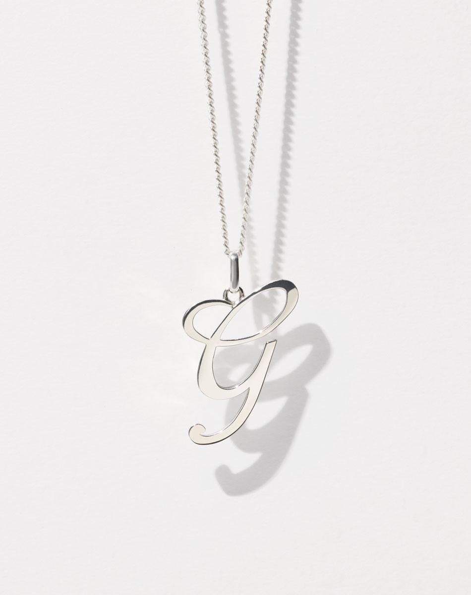 Meadowlark Jewellery's elegant Cursive Letter Charm Necklace in Sterling Silver. To symbolise the initials of someone you love or as a sweet gift to yourself. Each letter charm is crafted in our Tāmaki Makaurau Auckland studio, and strung on a 50cm fine chain.