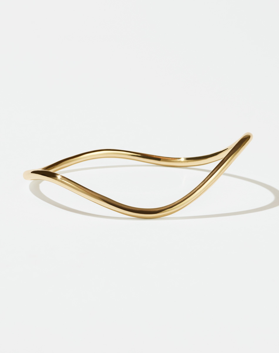 Meadowlark Jewellery&rsquo;s Bliss Bangle in 9ct Solid Yellow Gold. An organic and curvy rounded band, embodying a dynamic interplay of soft curves against geometric precision. From the Pleasures collection.