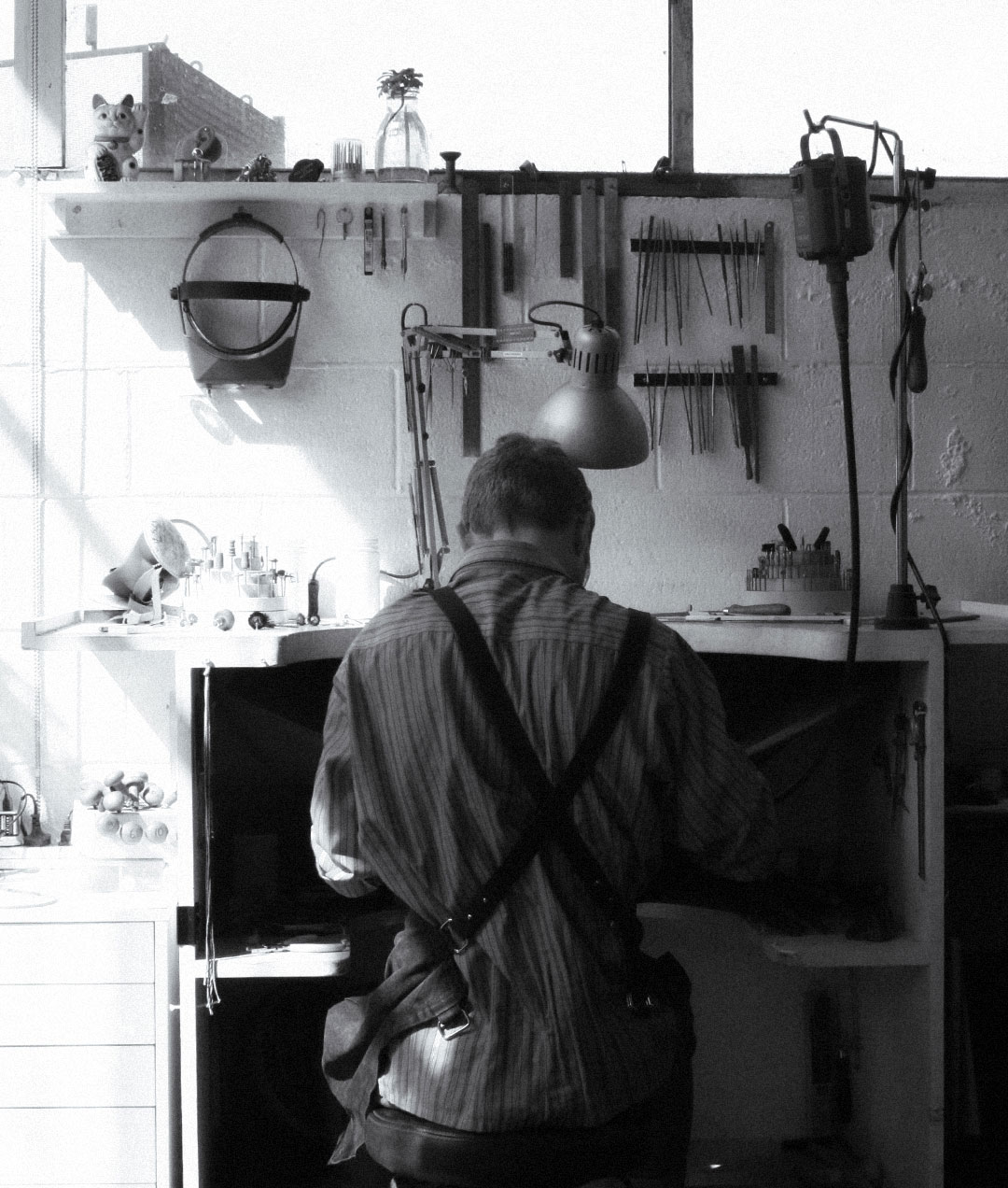 A jeweller at the bench in the Meadowlark workshop in Auckland New Zealand