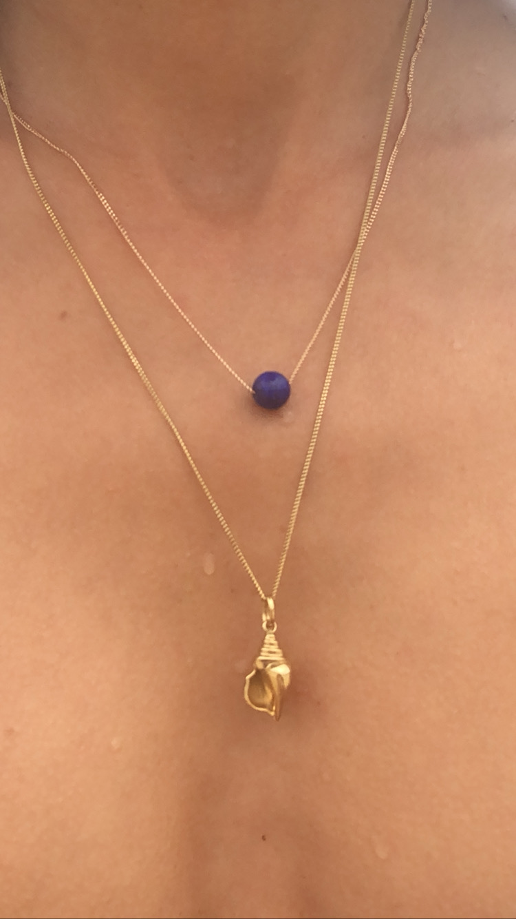 Ilkin wearing the Maya Necklace and Conch Charm Necklace.